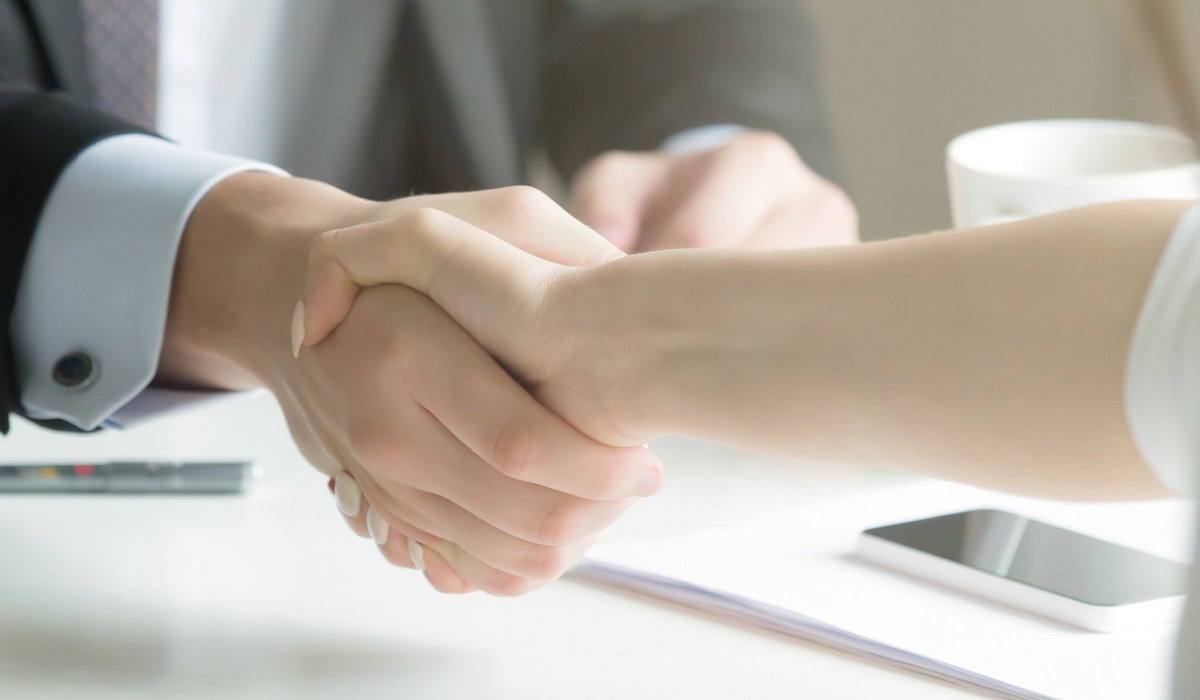 Man and woman shaking hands after a business agreement